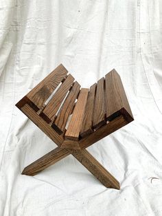 a wooden bench sitting on top of a white sheet