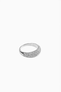 Boasting an eye-catching dome design, our signauture Layla ring in pavé is embellished with radiant simulated diamond stones that glimmer beautifully in the light. Its luxurious appearance and modern flair make it an exceptional choice to elevate any jewelry collection.- Stainless steel base - Simulated diamond accents- Width: 0.2" / 5mm x 0.1" / 2.5mm - Available in sizes 6, 7, 8 - Available in gold + silver - Engraved with signature MC branding- Hypoallergenic, non-tarnish, water-resistant Modern Dome Ring With Diamond Accents, Glamorous Diamond Rings With Rhinestones, Glamorous Sparkling Round Diamond Ring, Glamorous Sparkling Diamond Ring, Dazzling Diamond Ring With Rhinestones, Glamorous Round Diamond Ring With Sparkling Stones, Modern Sparkling Cubic Zirconia Rings, Dazzling Rhinestone Rings, Formal Diamond Ring With Rhinestones