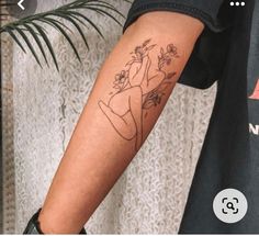 a person with a flower tattoo on their arm