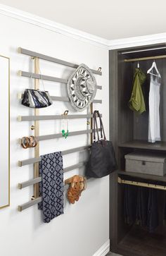 a closet with clothes hanging on the wall