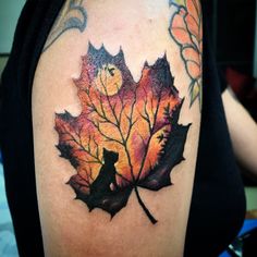 a leaf tattoo with a cat on it