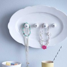 a white plate topped with bracelets and beads