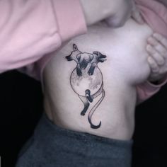 a woman's stomach with a cow tattoo on her belly and the bottom part of her lower back