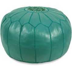 a green leather poufle with an intricate design