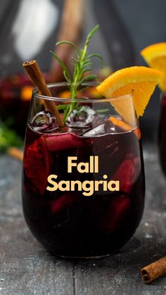 two glasses filled with fall sangria on top of a table