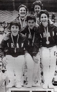 the baseball team is posing for a photo with their medals on top of each other