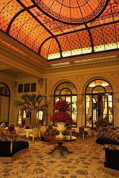 an ornately decorated lobby with chandelier and couches