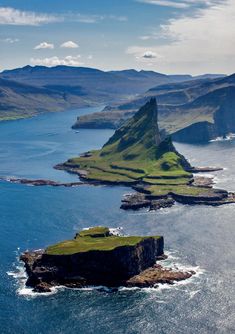 an island in the ocean surrounded by mountains