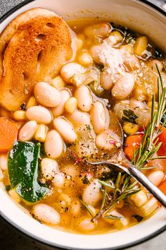 a white bowl filled with beans and vegetables