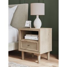 a night stand with two drawers and a lamp on the end table next to it