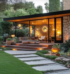 an outdoor living area is lit up with lights