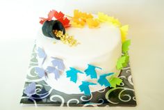 a white cake with colorful decorations on it