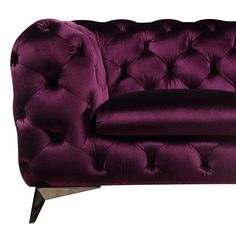 a purple velvet couch with wooden legs and buttons on the armrests is shown in front of a white background