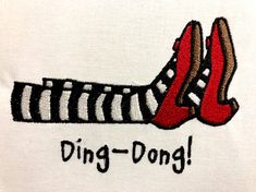 a pair of red shoes sitting on top of a white t - shirt that says, ding - dong