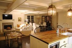 a kitchen and living room are shown in this image from the dining room looking into the family room