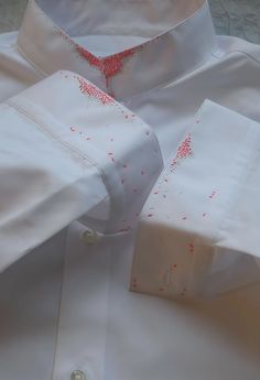 a white dress shirt with red sprinkles on it