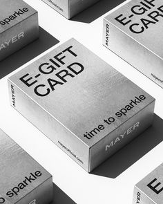 several silver boxes with the words e - gift card printed on them, all stacked together