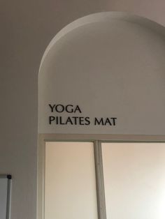 the yoga pilates mat sign is on the wall