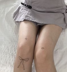 two women with small tattoos on their legs