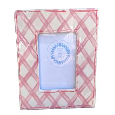 a pink and white plaid photo frame with a blue ribbon around the edge, in front of a white background