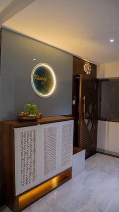 the front desk is decorated with an illuminated circle above it and on top of a wooden cabinet