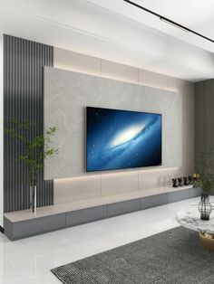 a large flat screen tv mounted on the wall in a living room with modern furniture