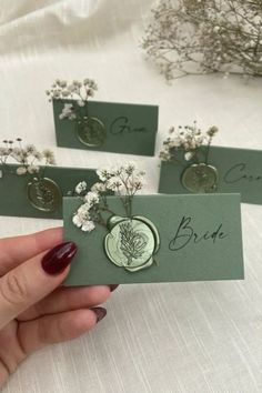 three cards with flowers are held in their hands