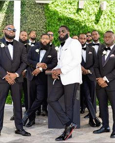 a group of men in tuxedos standing next to each other