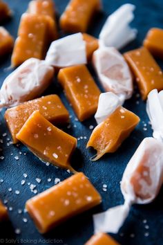 some pieces of food that are on a blue surface with white and brown sugar sprinkles