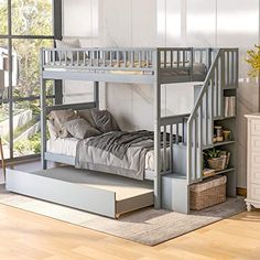 a bunk bed with stairs is in the middle of a room next to a window