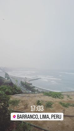 an image of a beach with the ocean in the background and foggy skies above