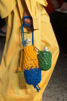 a close up of a person holding a handbag