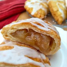 two pastries on a white plate with icing