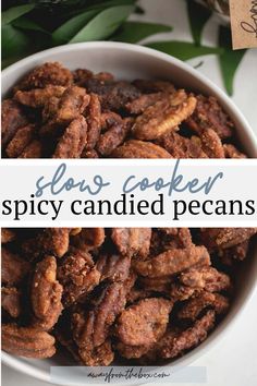 a bowl filled with candied pecans sitting on top of a table