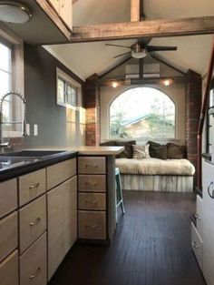 the interior of a tiny home with wood flooring