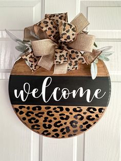 a leopard print welcome sign hanging on a door