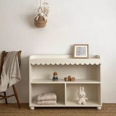 a white shelf with some stuffed animals on it