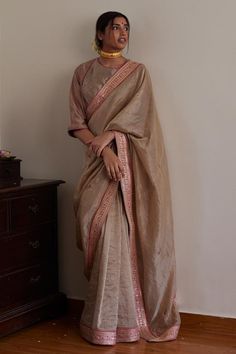 Brown phulwari saree in handloom tissue embellished with lace border. Paired with a chai angrakha blouse in chanderi and handloom tissue embellished with delicate embroidery and hot pink piping.
Components: 2
Pattern: Embroidered
Type Of Work: Lace
Neckline: Round
Sleeve Type: Three-quarter
Fabric: Saree: Handloom Tissue, Blouse: Chanderi, Handloom Tissue
Color: Brown
Other Details: 
Length:
Saree: 5.5 mtrs
Disclaimer: Since all our products are sustainable, touched by human hands be it weaving, Festive Bollywood Pre-draped Tussar Silk Saree, Festive Pre-draped Tissue Silk Saree, Festive Cotton Silk Pre-draped Saree, Unstitched Tussar Silk Choli In Traditional Drape, Traditional Drape Pre-draped Saree With Pallu In Raw Silk, Traditional Drape Pre-draped Saree In Raw Silk, Diwali Raw Silk Pre-draped Saree With Zari Work, Bollywood Style Pre-draped Raw Silk Saree, Traditional Drape Raw Silk Blouse Piece