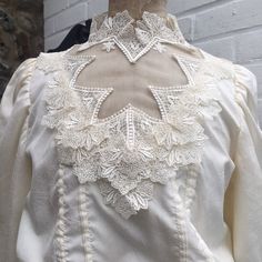 "Beautiful 80s wedding dress. Ivory synthetic textured fabric with synthetic lace trim. Lovely Victorian / Edwardian  style sleeves and bustle. High neckline.Roughly size small or size 8 Measured flat Chest 18\" Waist 12\" Pit to waist 8\" Pit to hem 40\" Skirt length 32\"" Fitted Victorian Wedding Dress With Ruffles, Fitted Victorian Dress With Ruffles For Wedding, White Fitted Victorian Dress For Formal Occasions, Cream Vintage Wedding Dress With Ruffles, Cream Vintage Dress With Ruffles For Wedding, Fitted Cream Victorian Dress With Long Sleeves, Formal White Victorian Dress With Lace Work, White Victorian Dress With Fitted Bodice For Vintage Events, Fitted Cream Victorian Dress For Wedding