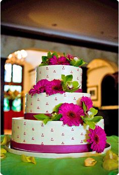 a three tiered cake with pink flowers on top