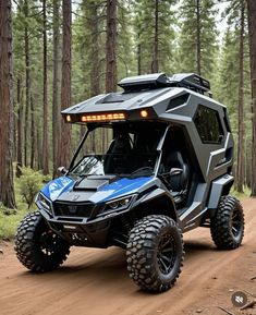 an off - road vehicle driving on a dirt road in the woods with its lights on