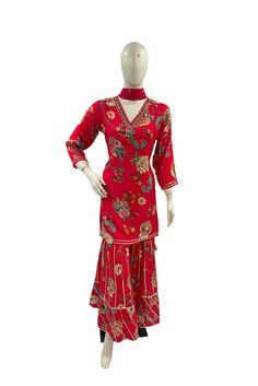 A meticulously crafted three-piece ensemble, tailored for special gatherings, bedecked in a luscious shade of red. This monochrome attire comprises a top, bottom, and a dupatta, each meticulously designed to enchant. The top, adorned with elbow-length sleeves, showcases intricate floral prints throughout and a highlighted neckline, elevating its allure. Delicately scattered sequins bestow a subtle radiance upon the ensemble. The accompanying palazzo pants, harmonizing in matching hues and patter Printed Sharara Suit, Printed Sharara, Shade Of Red, Sharara Suit, Suit Set, Elbow Length Sleeve, Photographic Lighting, Palazzo Pants, Shades Of Red