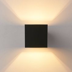 a square light fixture mounted on the wall