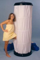 a woman standing next to a tall white object