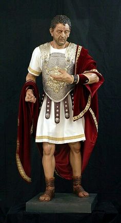 a statue of a man dressed in roman garb and holding his hands out to the side