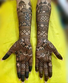 two hands with henna tattoos on them