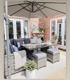 an outdoor living area with patio furniture and umbrella