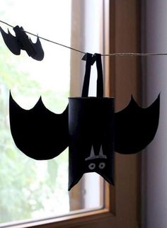 some paper bats hanging from a clothes line