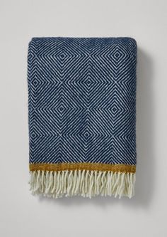 a blue and white blanket with fringes