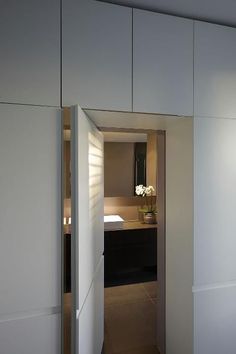 an open door leading to a bedroom with white walls